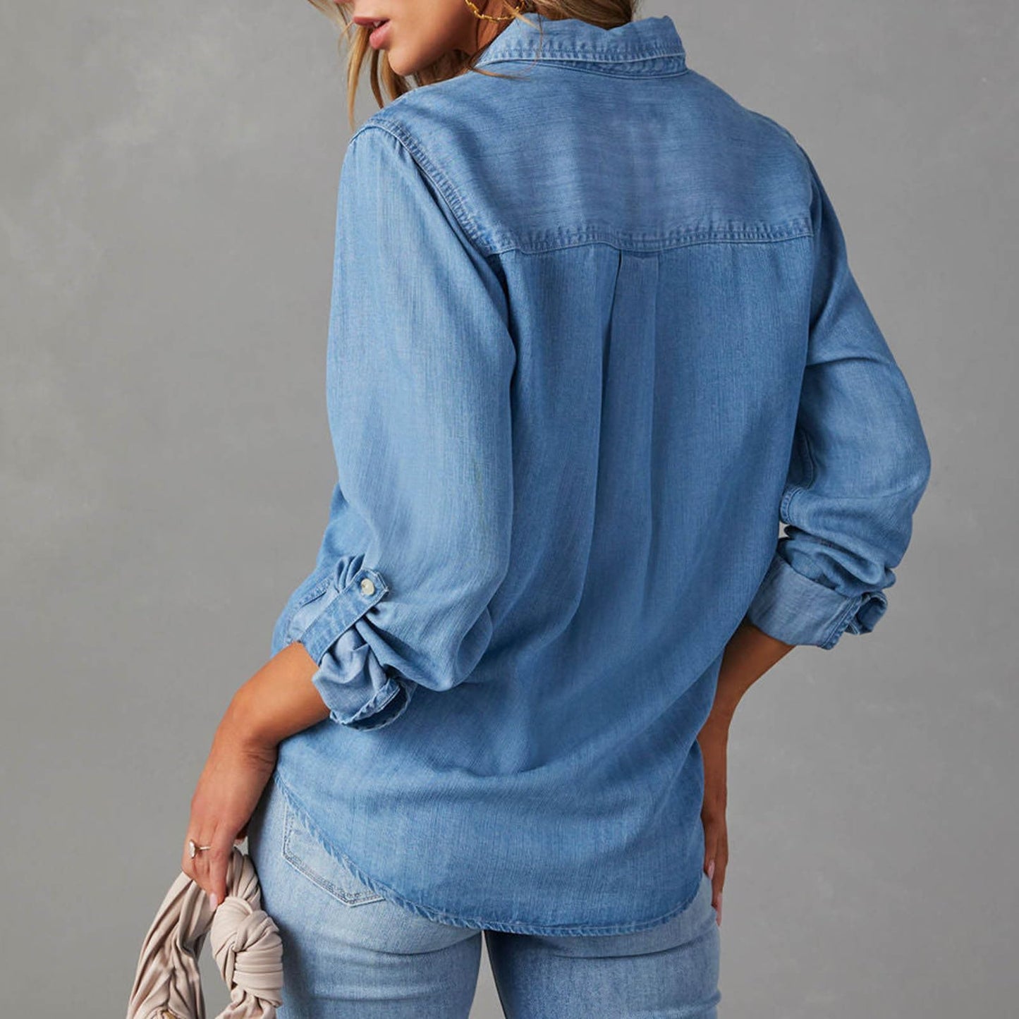 Back view of casual distressed denim shirt showing tunic-length hem and lightweight fabric