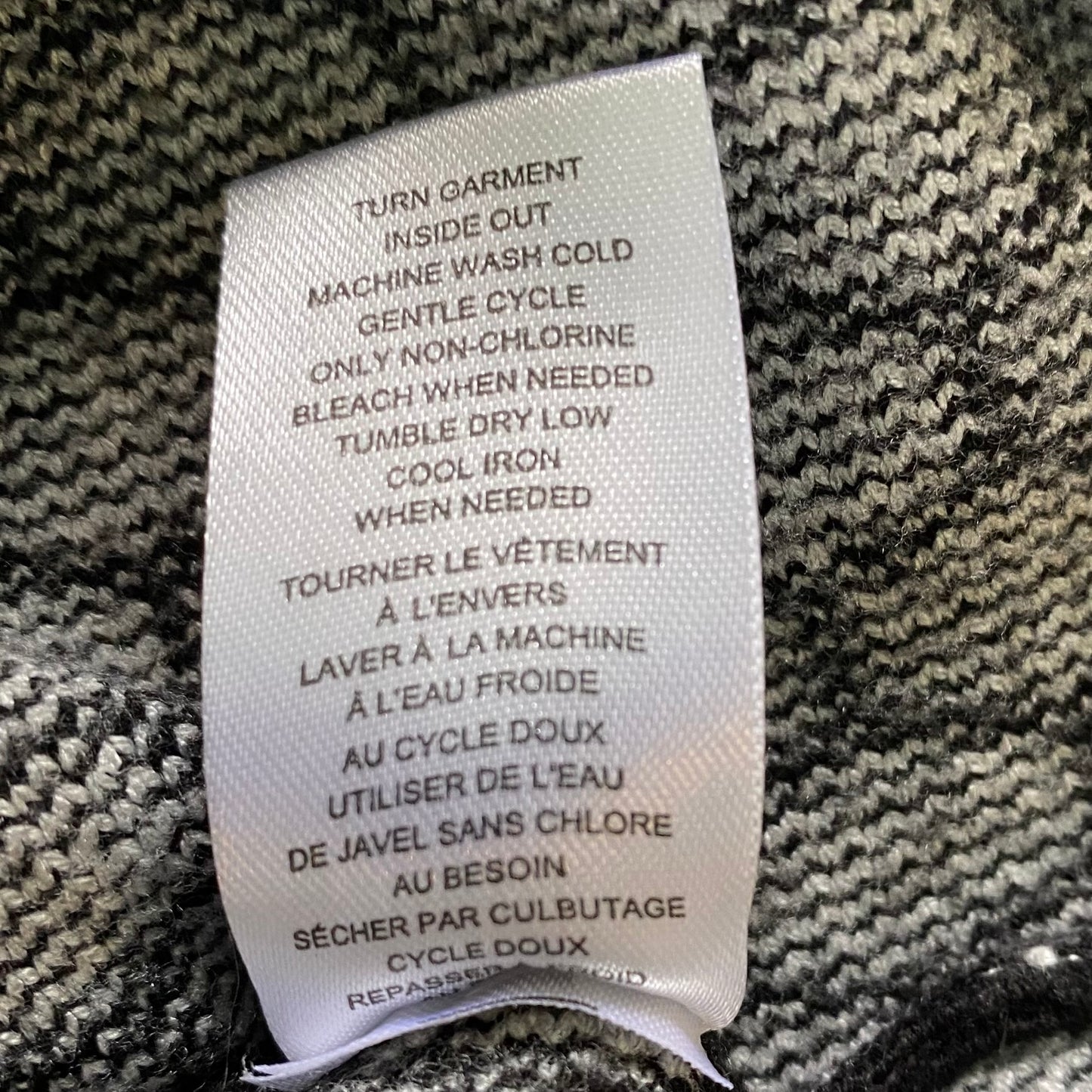 Women's Geometric Knit Sweater – Chic & Cozy – Size Medium (Industry) showing care instruction tag