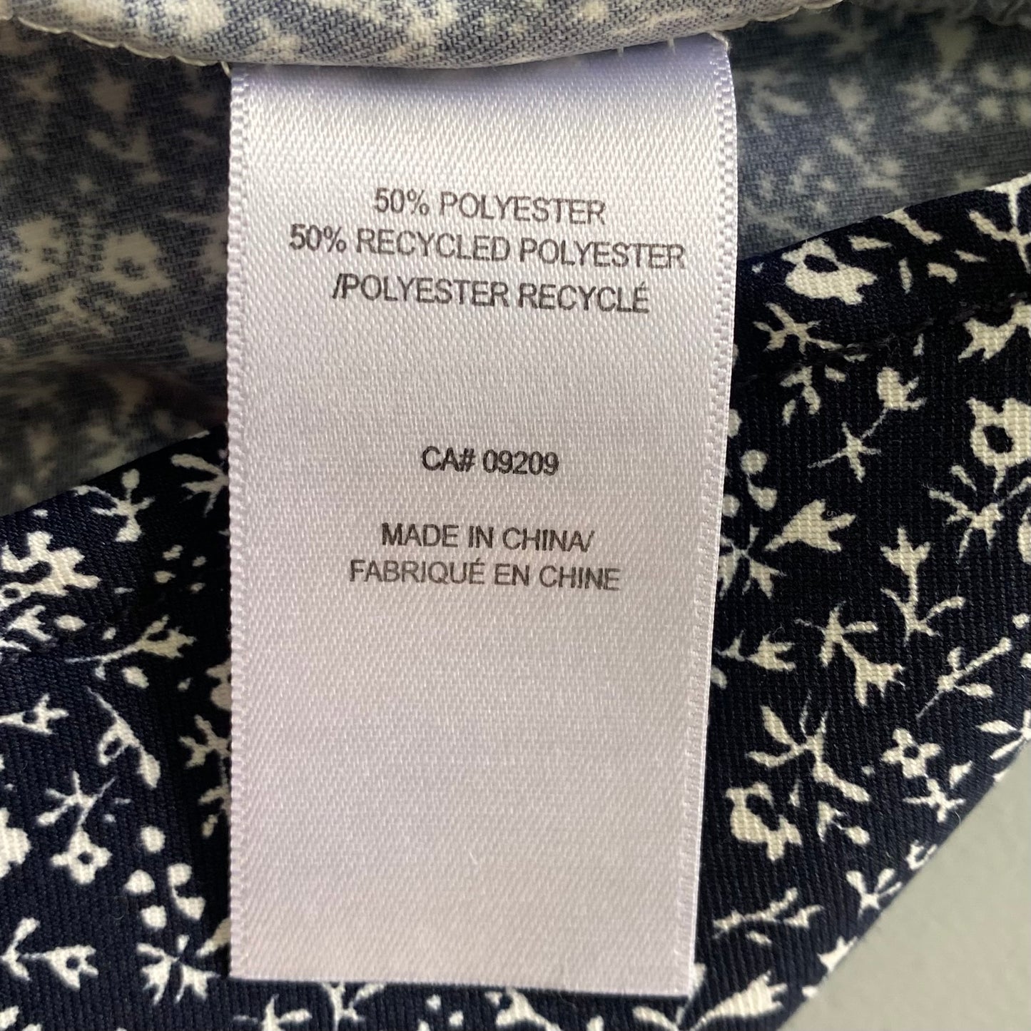 Navy Sleeveless Blouse – Micro Floral Print – Lightweight & Sustainable – Size M (Cleo) garment tag