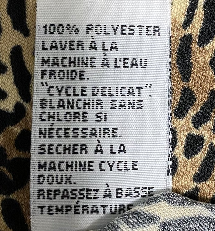animal print top fabric details and washing care instructions on the tag
