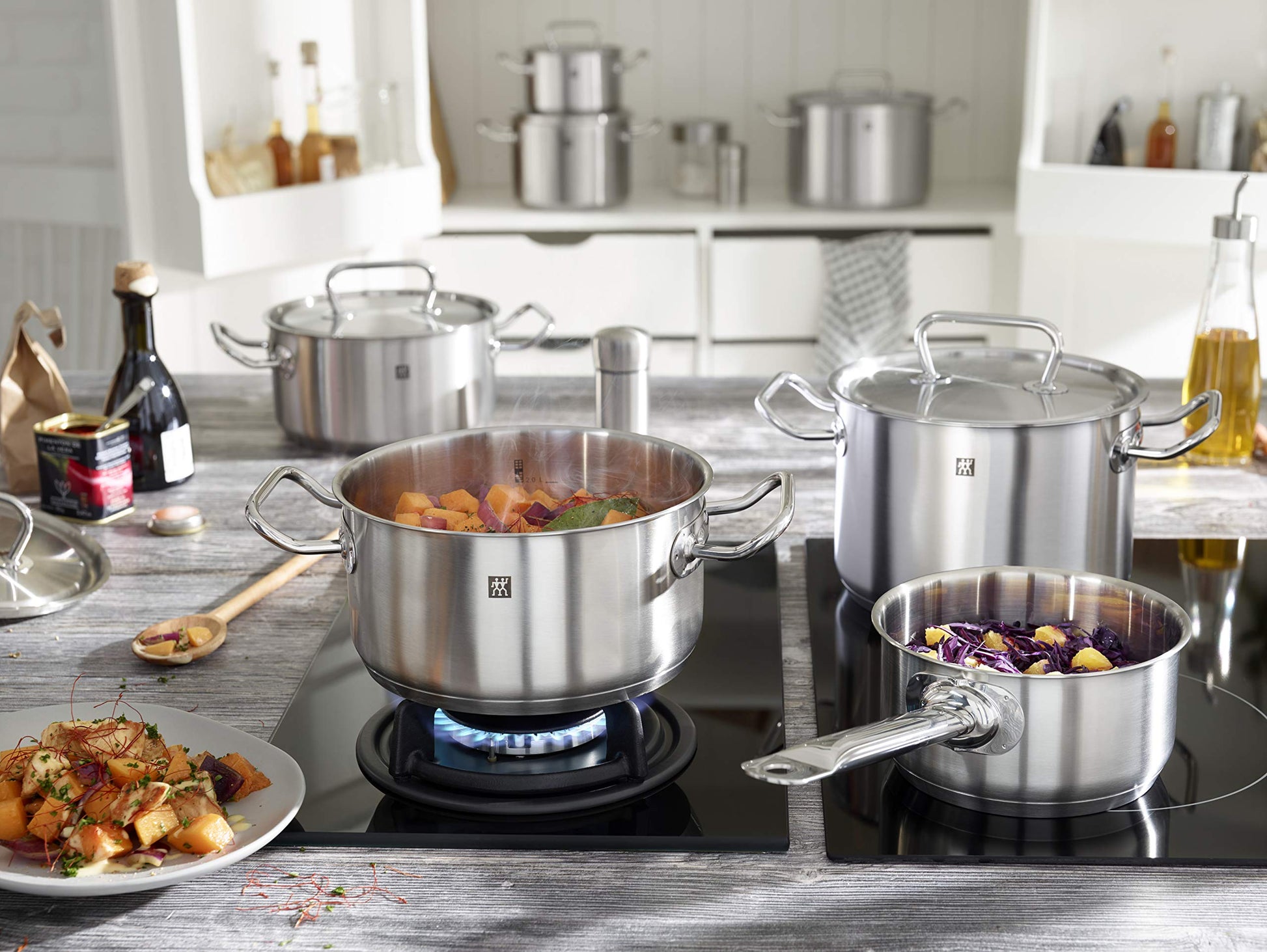 ZWILLING Twin Classic 12-Piece Stainless Steel Cookware Set – All Cooktops – Dripless Rims + Integrated Measuring Scale being used on a stove