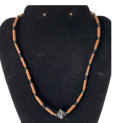 Handcrafted Wood & Bead Necklace – Rustic Boho Jewelry with Metal Accent shown on black form