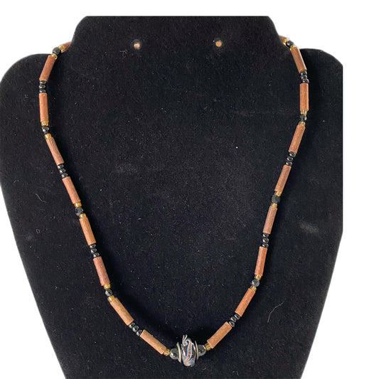 Handcrafted Wood & Bead Necklace – Rustic Boho Jewelry with Metal Accent shown on black form