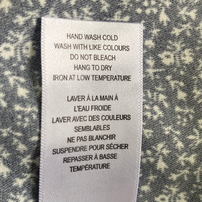 Navy Sleeveless Blouse – Micro Floral Print – Lightweight & Sustainable – Size M (Cleo) garment tag